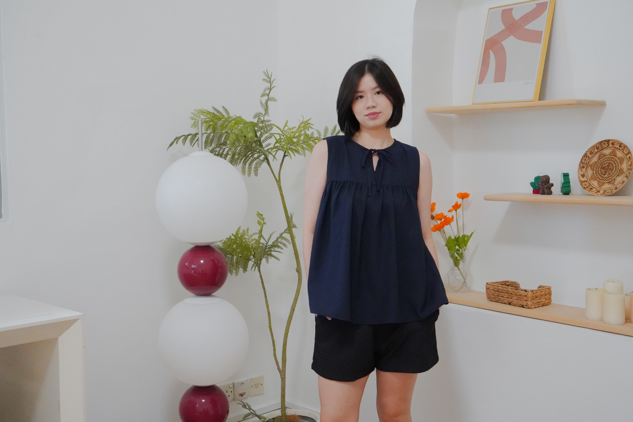 Evie navy sleeveless top styled with black shorts from The Fleur Label