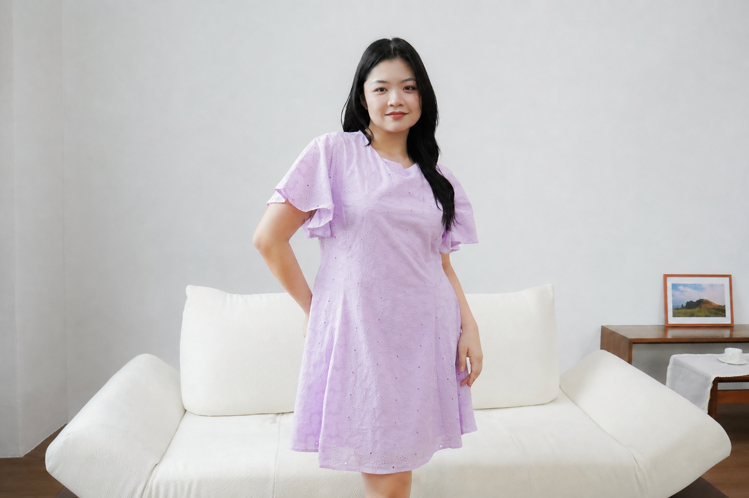 Model wearing a lavender eyelet dress from The Fleur Label